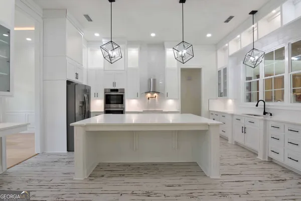 a view of a kitchen with a sink and refrigerator