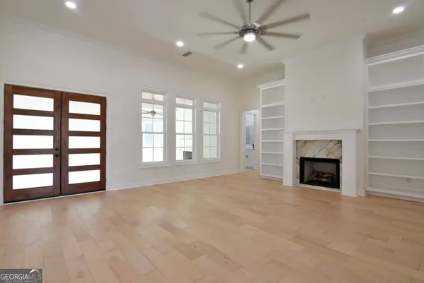 a view of an empty room with a fireplace and a window