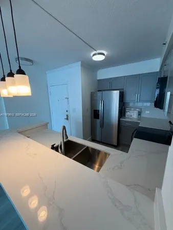 a kitchen with stainless steel appliances a refrigerator sink and stove