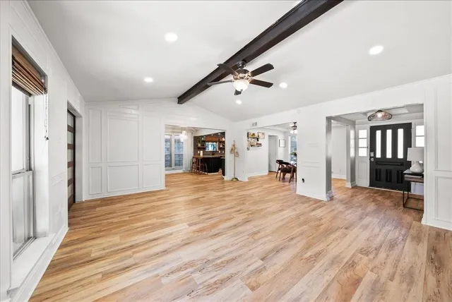 a view of empty room with wooden floor