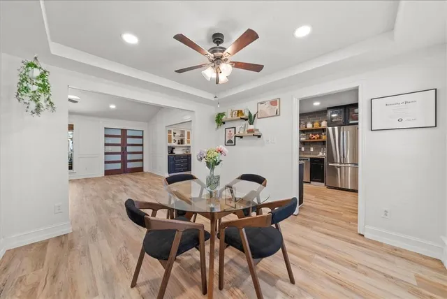 a view of a dining room with furniture and wooden floor
