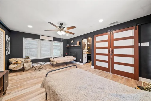 a bedroom with a large bed and a large window