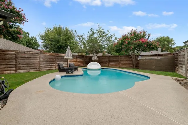 a view of a swimming pool with a yard