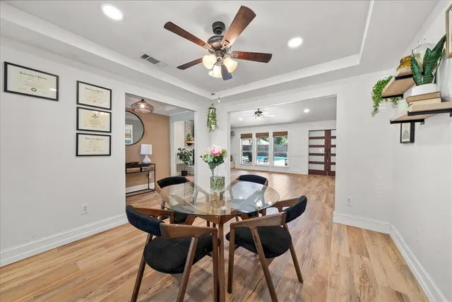 a view of a dining room with furniture and wooden floor