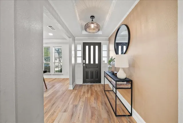 a view of a hallway view with wooden floor and entryway