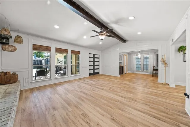 a big room with wooden floor and windows
