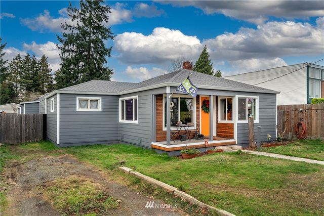 a view of a house with a yard and sitting area