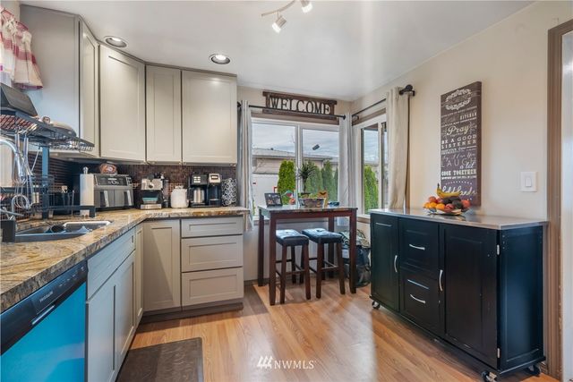 a kitchen with sink cabinets and dining table