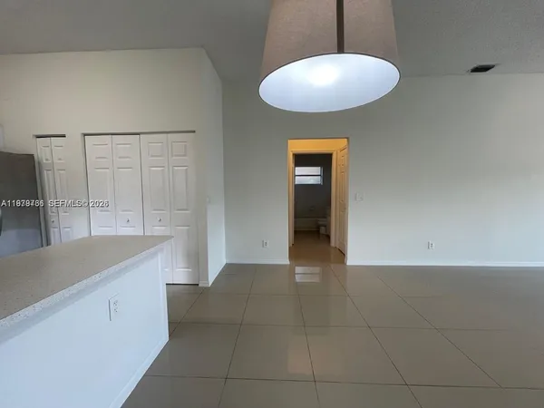 a view of a kitchen from the hallway