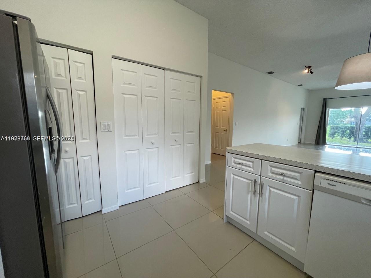 16309 Emerald Cove Road, Unit 16309 Weston, FL 33331 - Photo 13 of 41 a view of a kitchen with a sink and a refrigerator