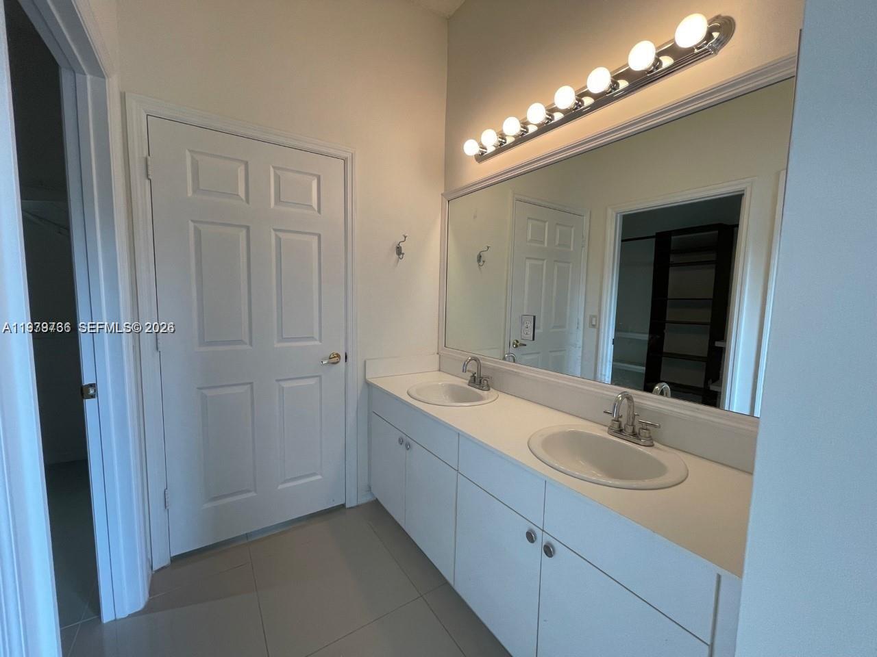 16309 Emerald Cove Road, Unit 16309 Weston, FL 33331 - Photo 26 of 41 a bathroom with a double vanity sink and a mirror