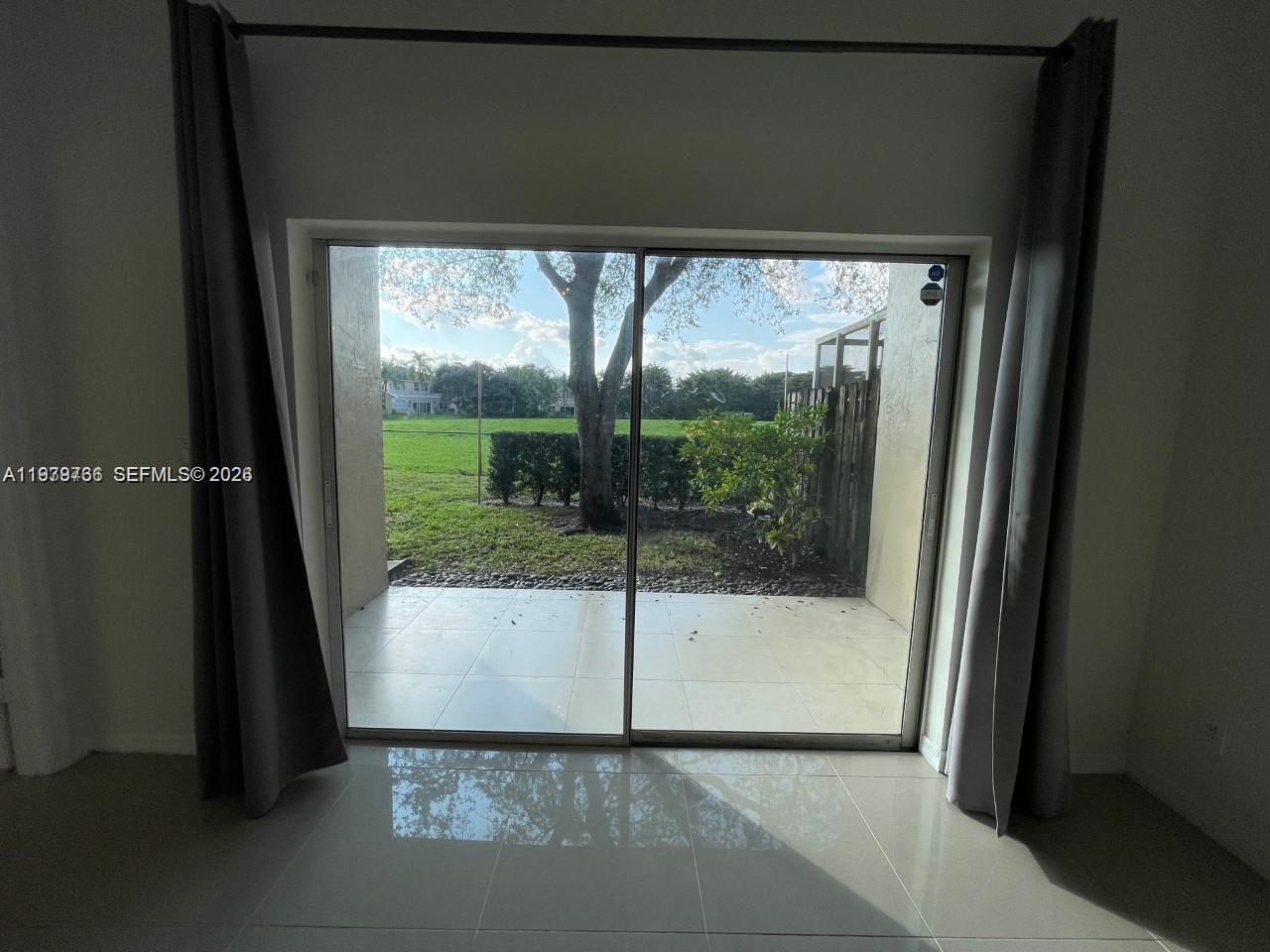 16309 Emerald Cove Road, Unit 16309 Weston, FL 33331 - Photo 28 of 41 a view of a porch with a floor to ceiling window