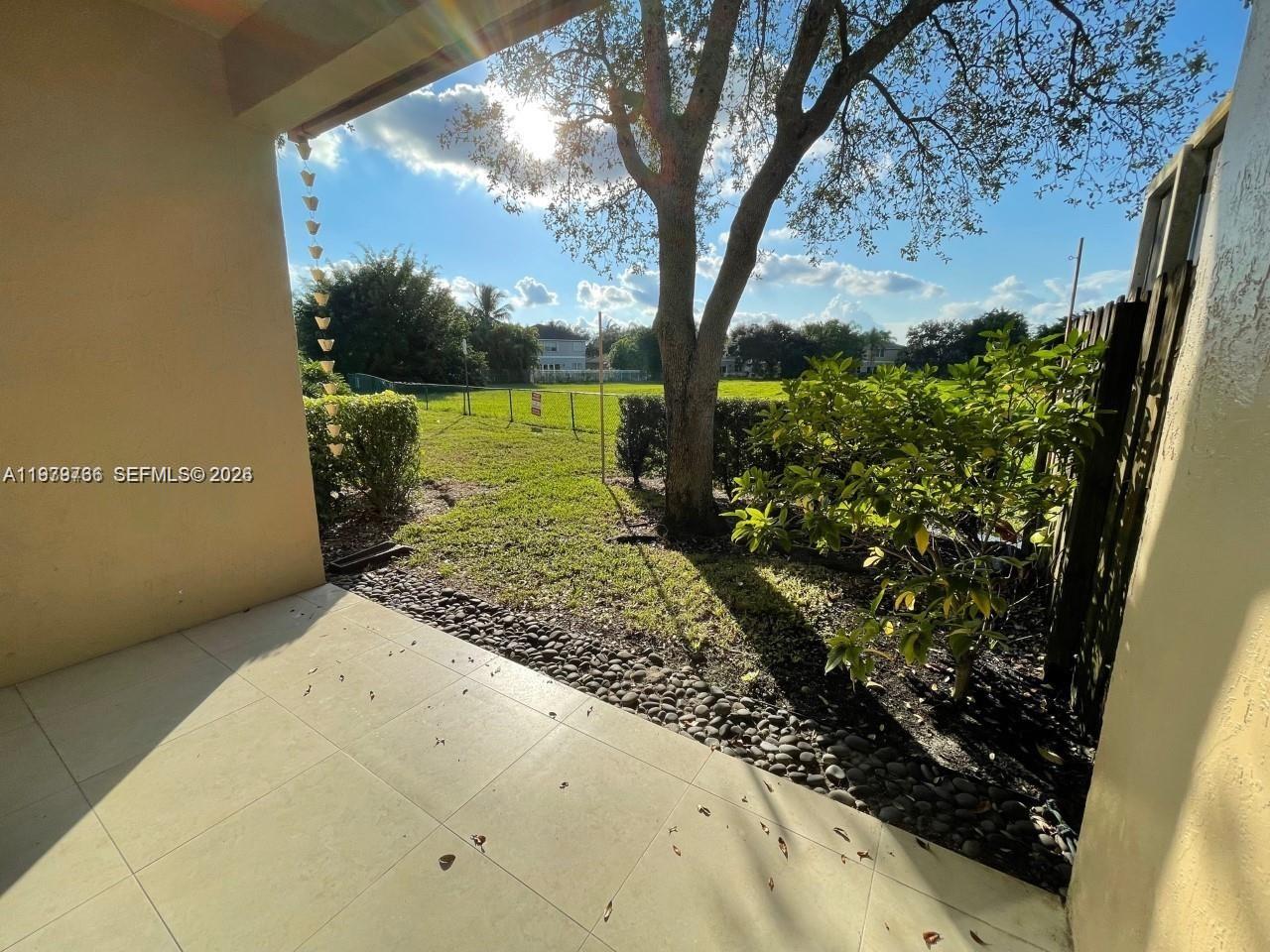 16309 Emerald Cove Road, Unit 16309 Weston, FL 33331 - Photo 29 of 41 a view of a yard with wooden fence