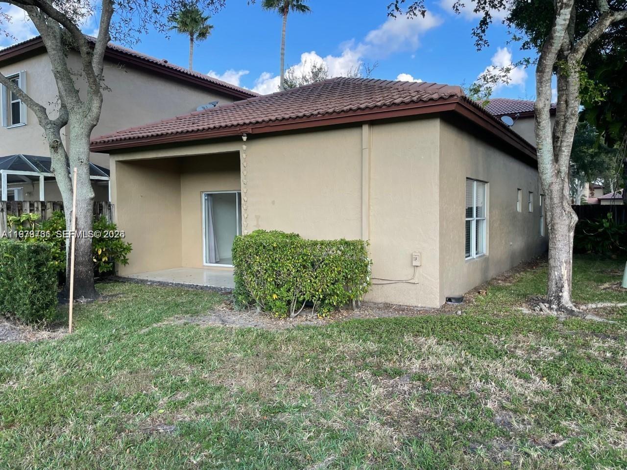 16309 Emerald Cove Road, Unit 16309 Weston, FL 33331 - Photo 30 of 41 a view of a house with a yard