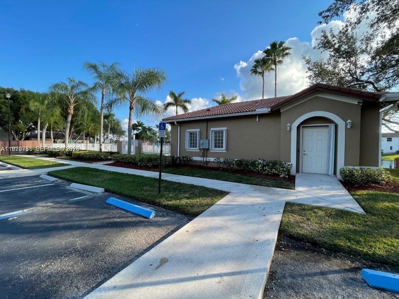 16309 Emerald Cove Road, Unit 16309 Weston, FL 33331 - Photo 34 of 41 a front view of a house with a yard