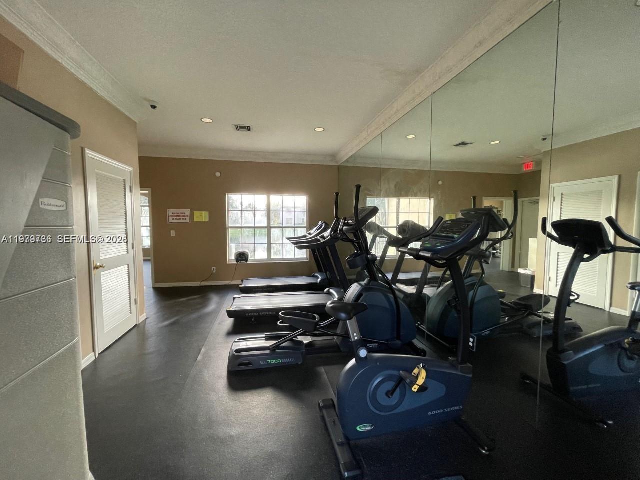 16309 Emerald Cove Road, Unit 16309 Weston, FL 33331 - Photo 35 of 41 a view of a room with gym equipment