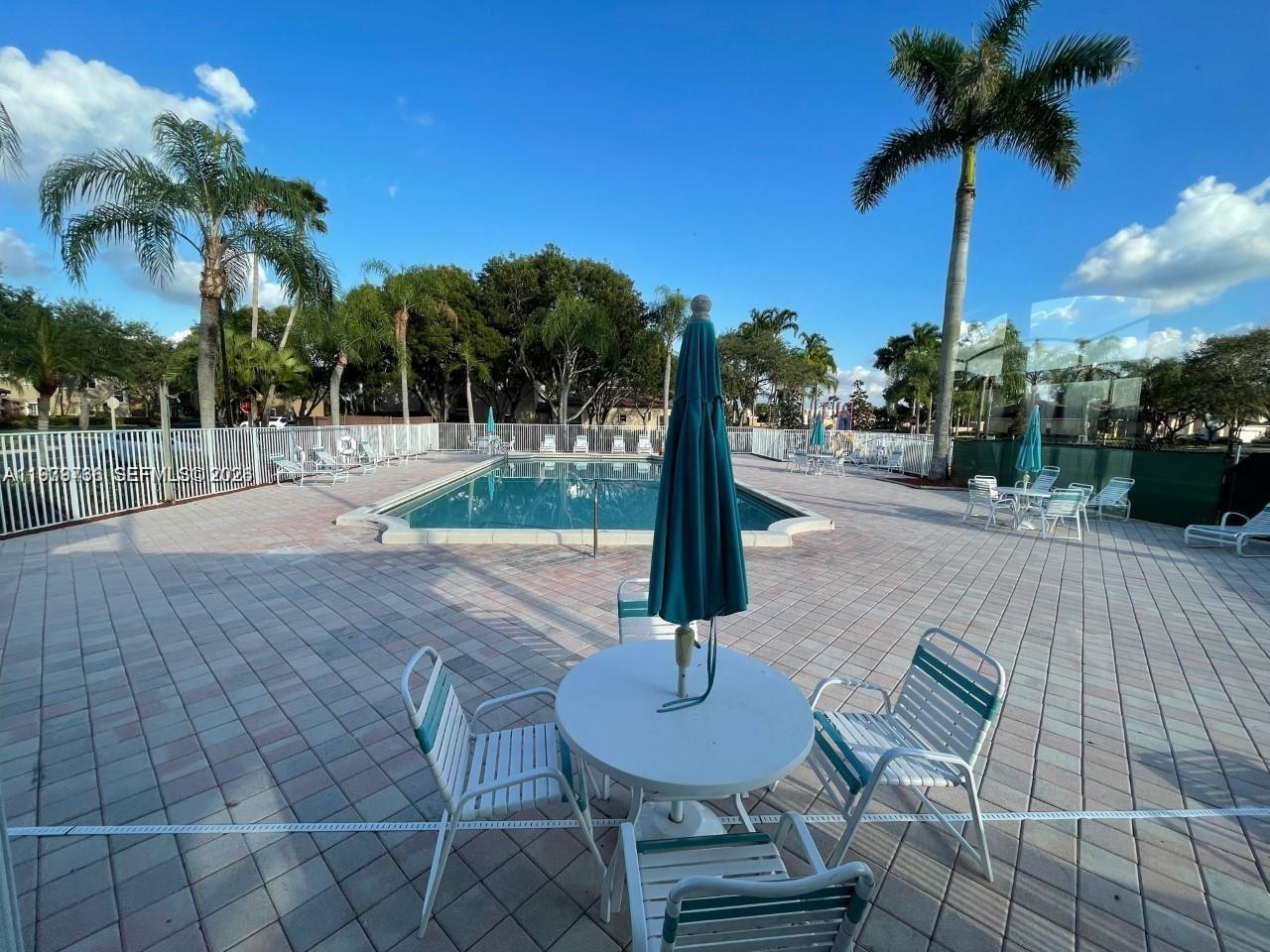 16309 Emerald Cove Road, Unit 16309 Weston, FL 33331 - Photo 37 of 41 a swimming pool with a yard