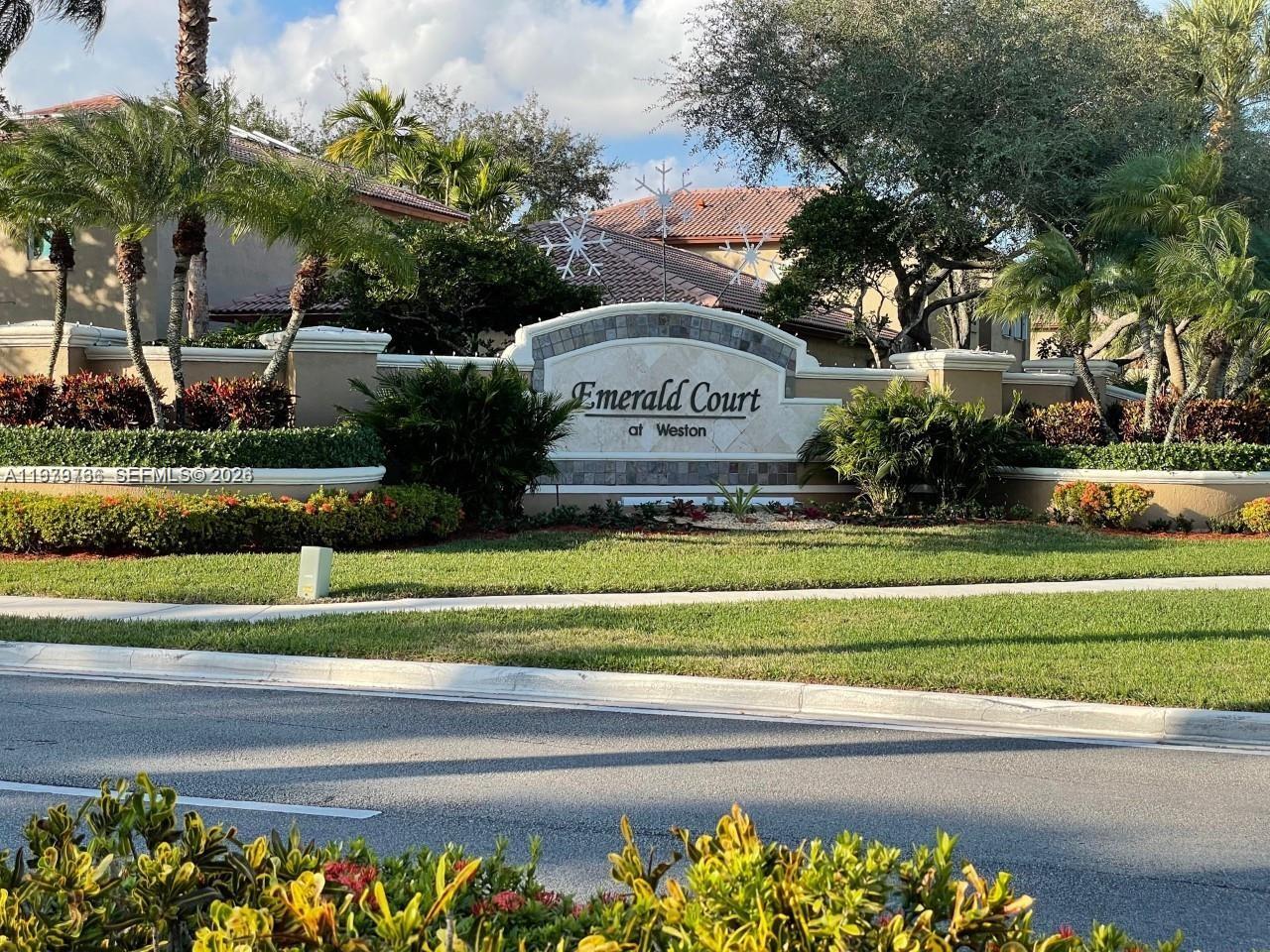 16309 Emerald Cove Road, Unit 16309 Weston, FL 33331 - Photo 39 of 41 a view of a park that has a large sign and a garden