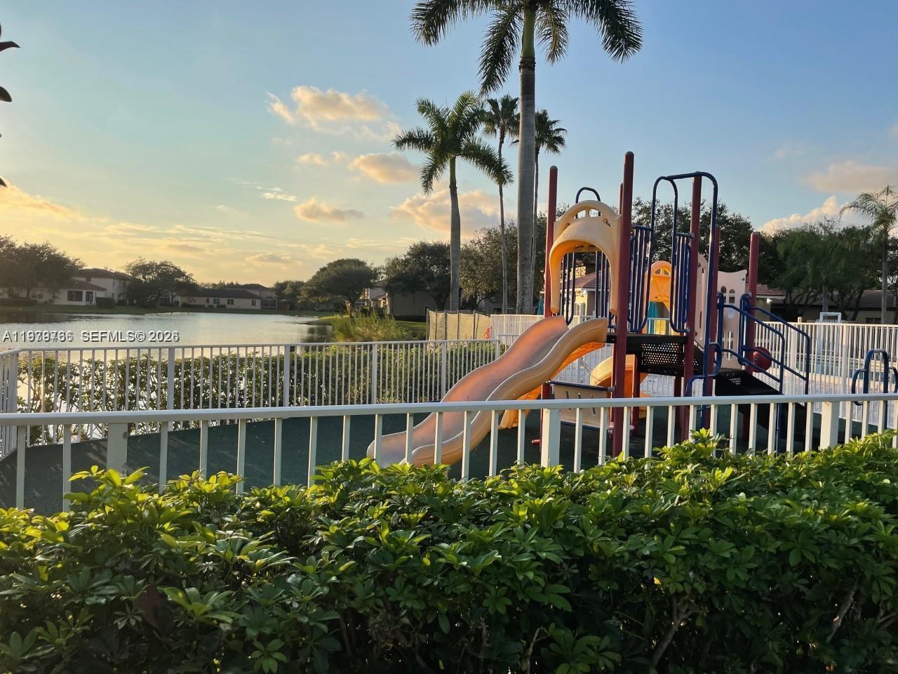 16309 Emerald Cove Road, Unit 16309 Weston, FL 33331 - Photo 41 of 41 a front view of a house with a garden