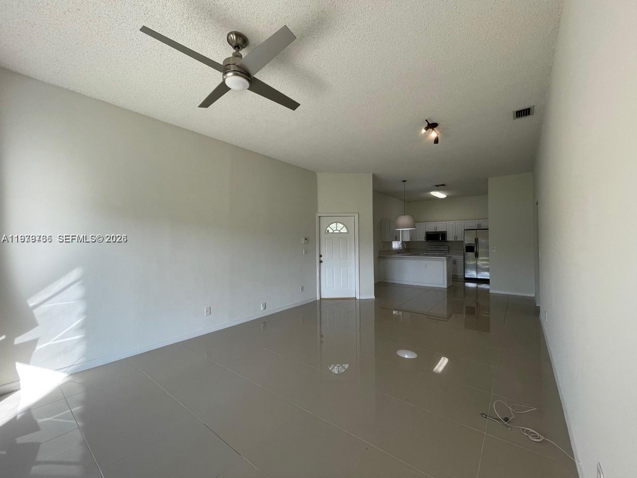 16309 Emerald Cove Road, Unit 16309 Weston, FL 33331 - Photo 5 of 41 wooden floor in an empty room with a ceiling fan
