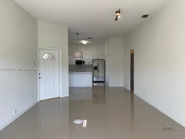 a view of a kitchen with a refrigerator a sink and dishwasher
