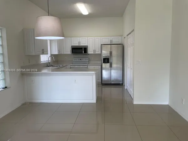 a kitchen with stainless steel appliances a refrigerator and a sink