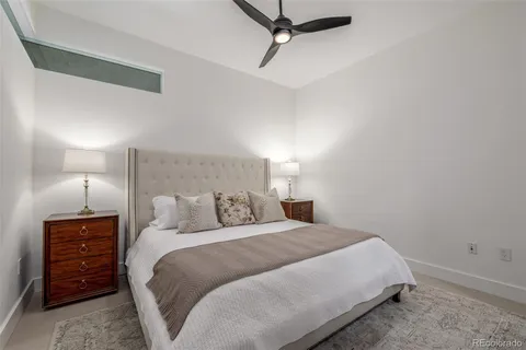 a bedroom with a bed and a night stand