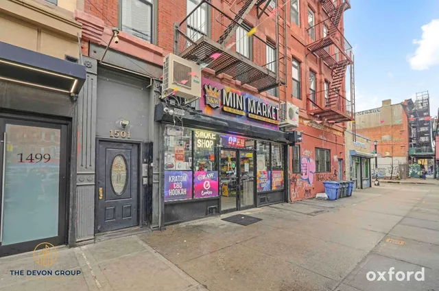 a view of a street with stores
