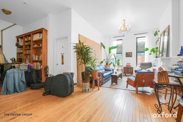 a living room with furniture a dining table and wooden floor