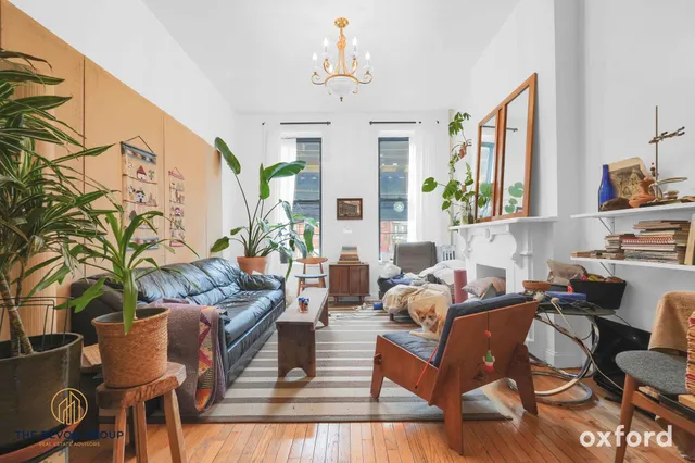 a living room with furniture fireplace and a large window