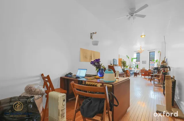 a work room with furniture and wooden floor