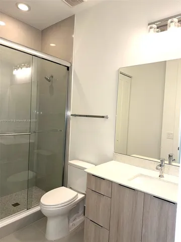 an empty room with wooden floor and closet