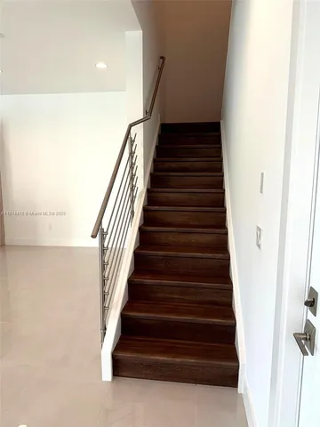 a bathroom with a shower sink and mirror