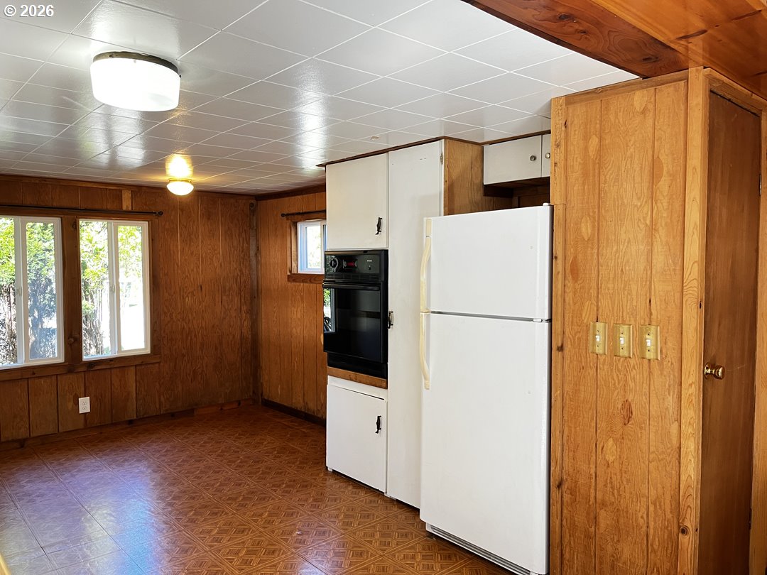85141 Cedar Drive Florence, OR 97439 - Photo 16 of 37 a view of a refrigerator in kitchen and wooden floor