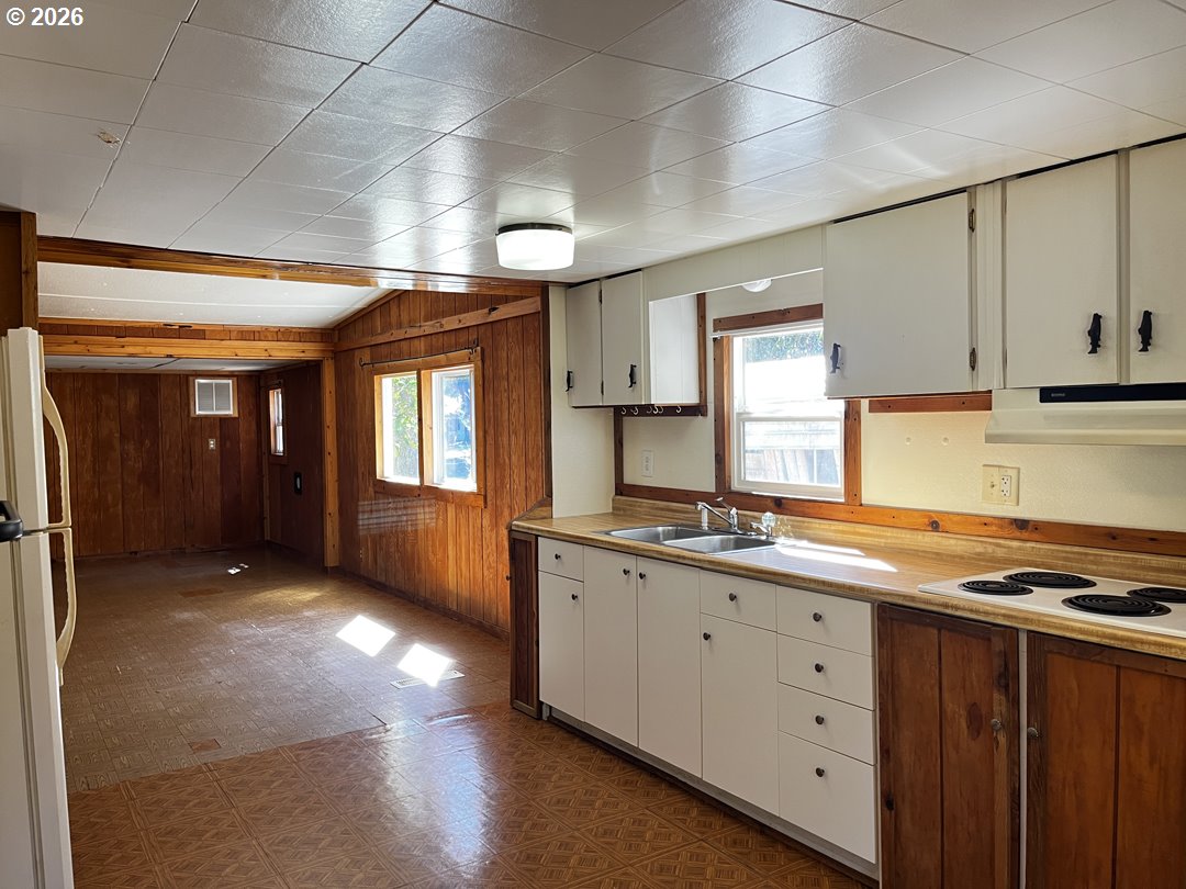 85141 Cedar Drive Florence, OR 97439 - Photo 17 of 37 a kitchen with granite countertop a sink cabinets and window