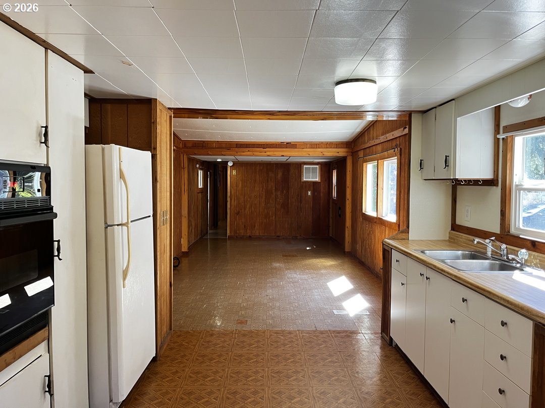 85141 Cedar Drive Florence, OR 97439 - Photo 18 of 37 a view of a kitchen with a refrigerator and a sink