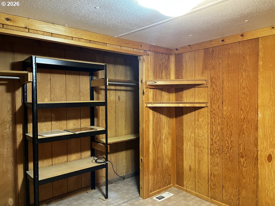 85141 Cedar Drive Florence, OR 97439 - Photo 26 of 37 a view of walk in closet with empty racks