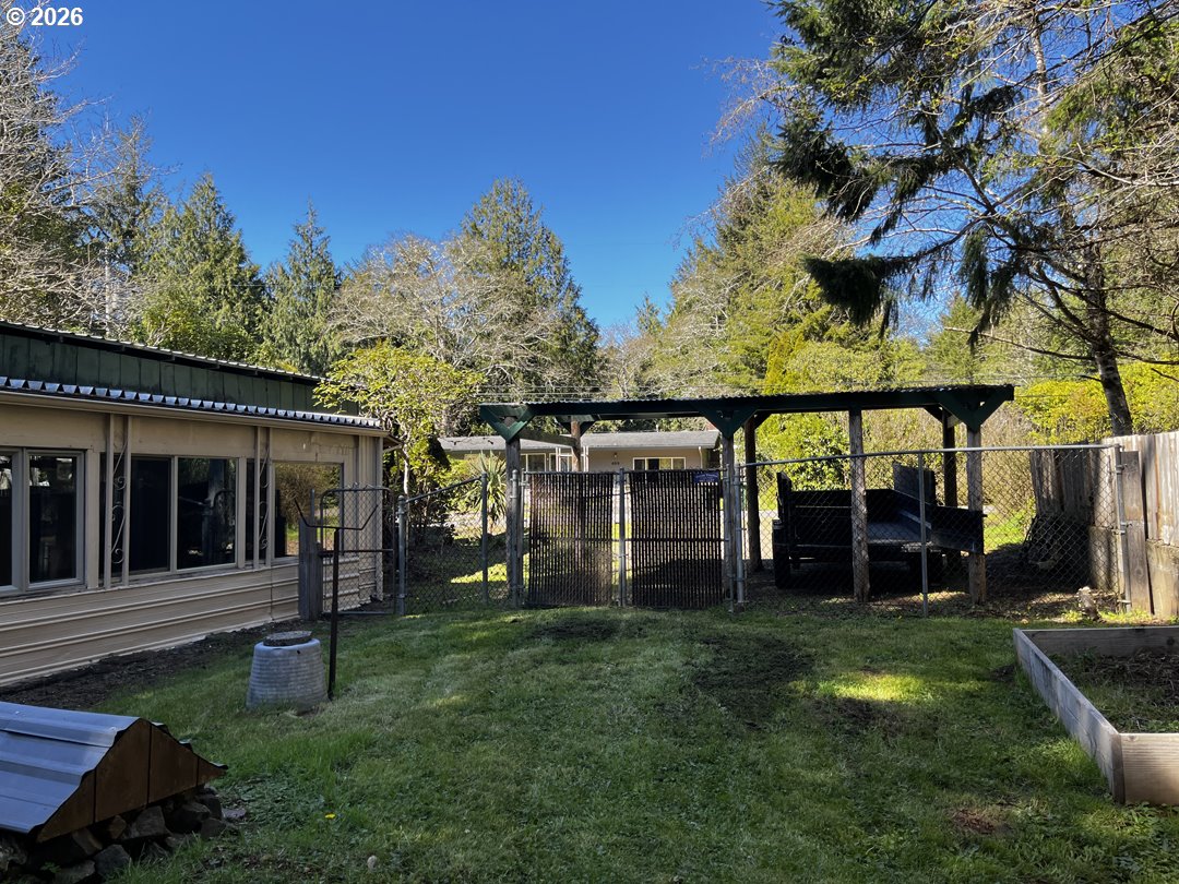 85141 Cedar Drive Florence, OR 97439 - Photo 8 of 37 a view of a house with backyard and porch
