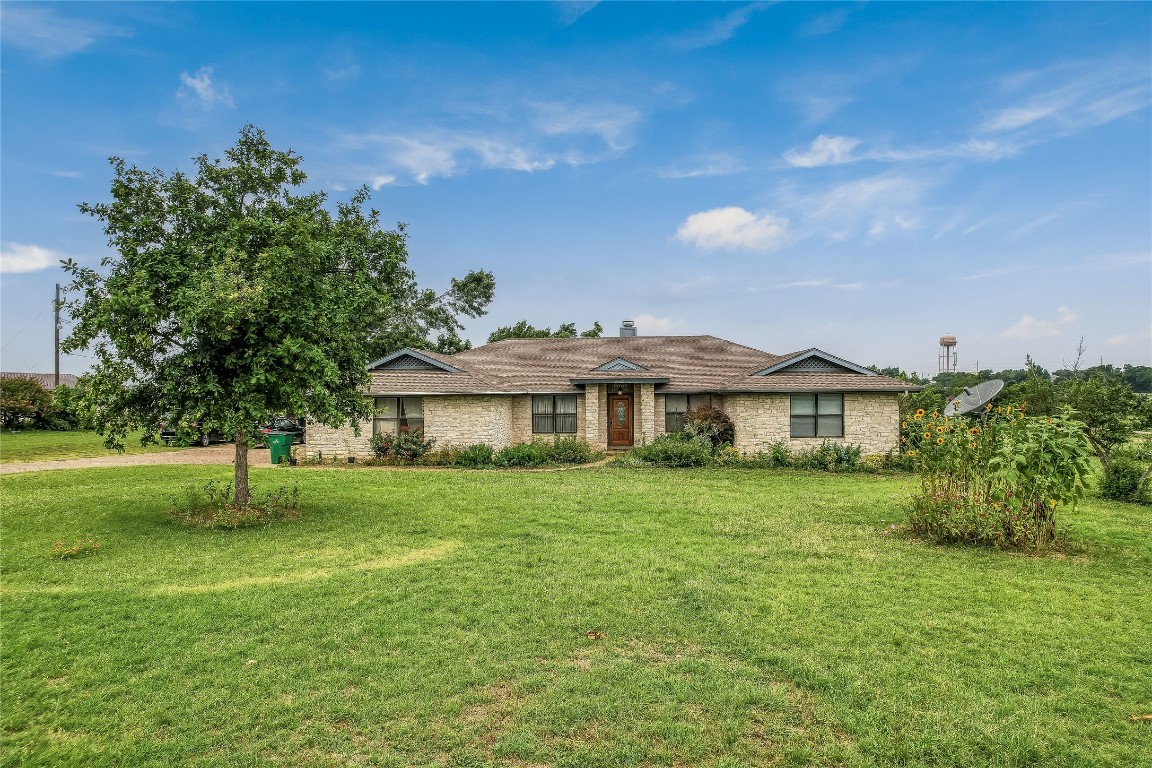 1931 Rowe Loop Pflugerville, TX 78660 - Photo 28 of 37 a view of a house with a big yard potted plants and large tree