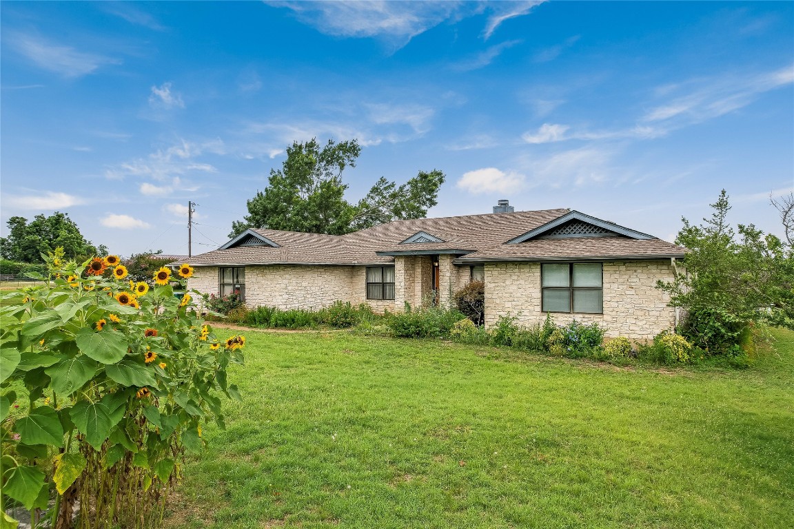 1931 Rowe Loop Pflugerville, TX 78660 - Photo 30 of 37 a view of a house with garden and a yard