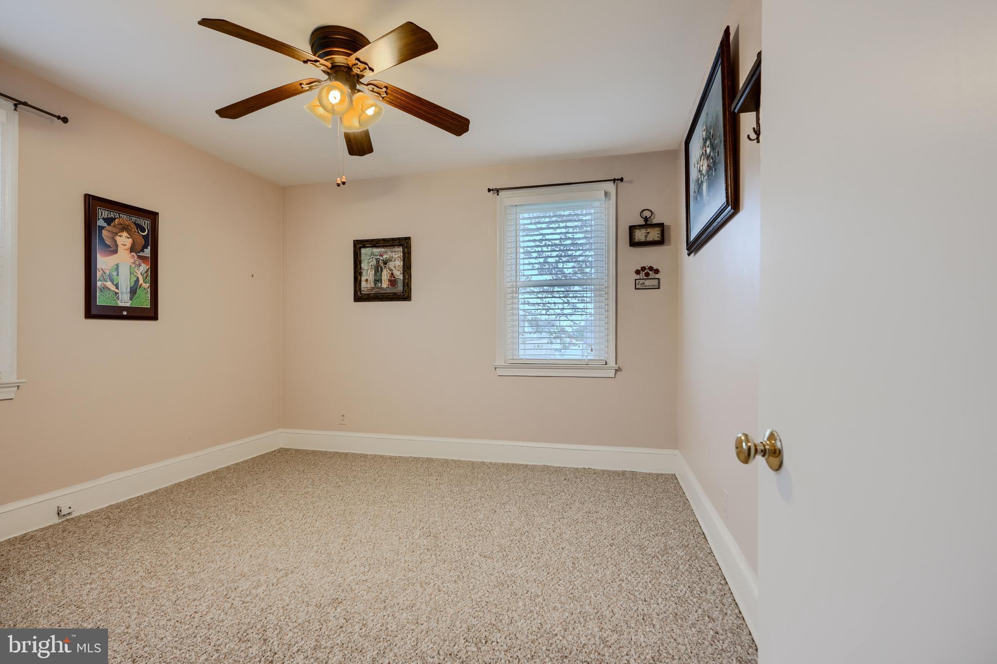 3119 White Way Road Baltimore, MD 21219 - Photo 20 of 41 an empty room with windows and fan