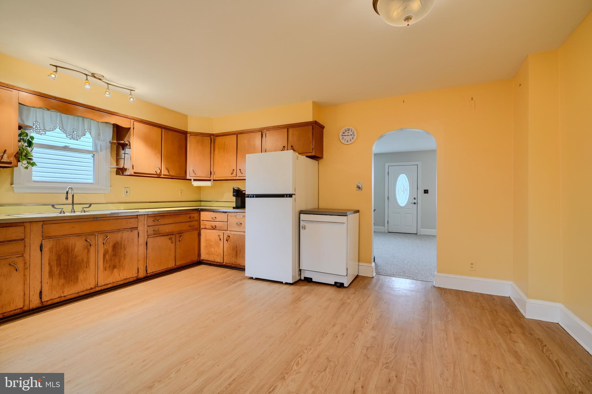 3119 White Way Road Baltimore, MD 21219 - Photo 8 of 41 a kitchen with wooden cabinets and white appliances