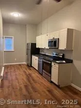 a kitchen with granite countertop a stove and a microwave