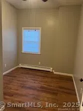 a view of a room with wooden floor