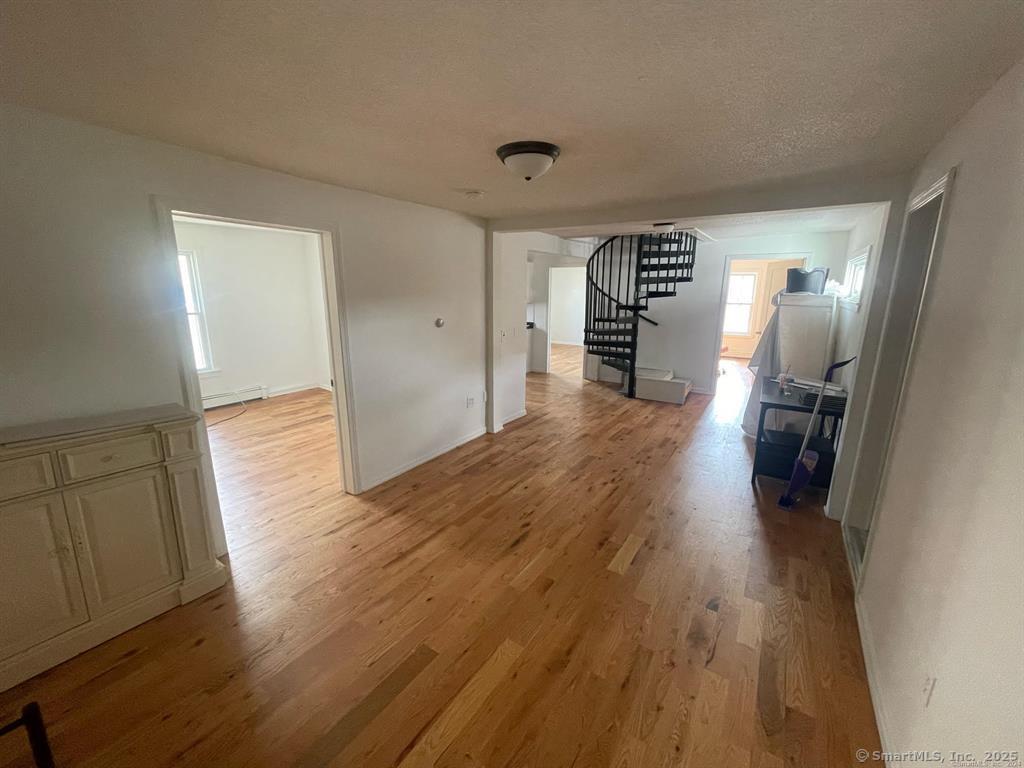 243 North Elm Street Torrington, CT 06790 - Photo 3 of 23 a view of a hallway with wooden floor