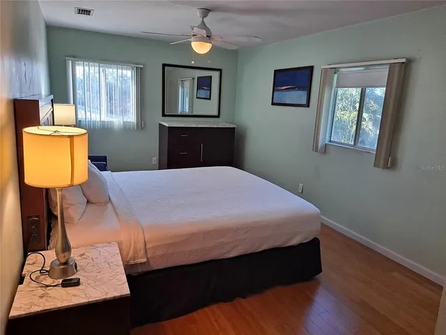 a bed sitting in a bedroom next to a window