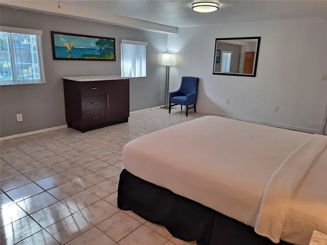 a bedroom with a bed and a desk