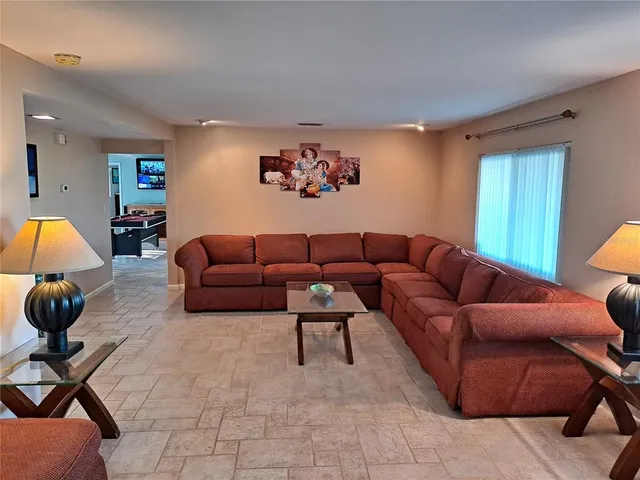 a living room with furniture and a gym cycle