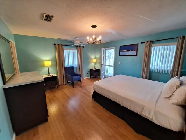 a bed room with a bed mirror and a window