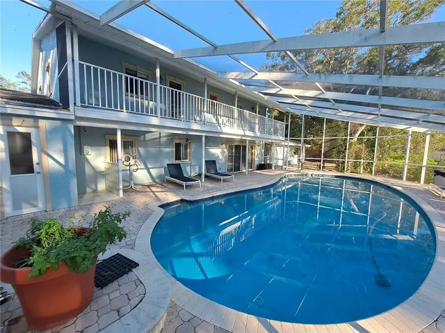 a view of a swimming pool with outdoor seating